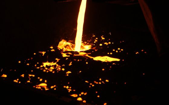 A metal casting into a form on a foundry