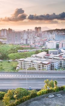 It is a cityscape photo of apartments and highway.