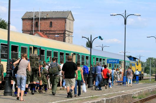 Crowd of people getting into the train on the station
