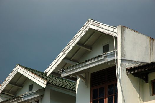 a house in the suburb area with blue sky as background