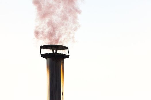 Smoking chimney of wood heated family home.