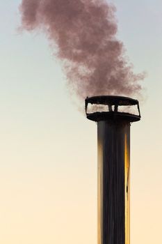 Black smoke emission from chimney polluting the environment.