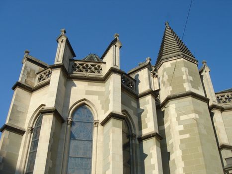 Enlightened side of of catholic church with blue sky