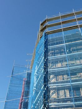 Side of scaffolding on building by beautiful weather