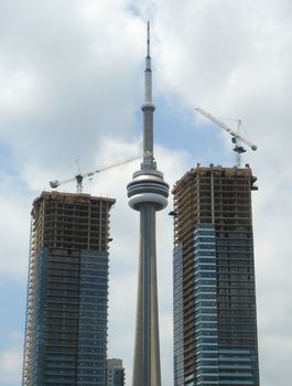 CN Tower in Toronto surrounded by buildings in construction