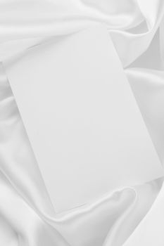White card on elegant white satin cloth