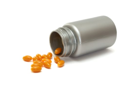 a grey plastic bottle with orange pills