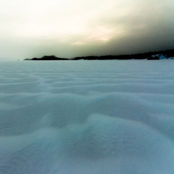 Bad winter weather windswept snowscape of drifting white powder snow.