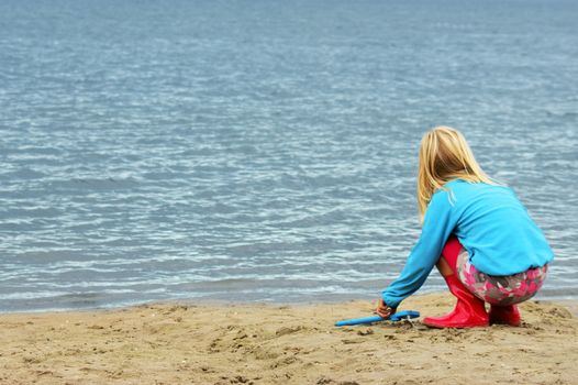 a girl is paying on the beach