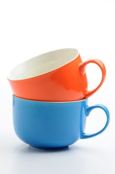 Two colorful ceramic mugs stacked.
