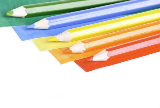 A colorful pencil crayons and scrapbooking papers ready for creative use.