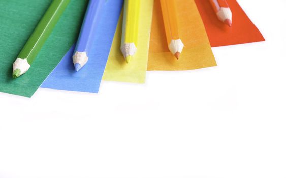 A colorful pencil crayons and scrapbooking papers ready for creative use.