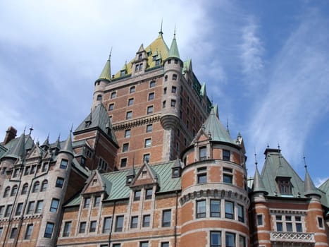 Towers of Frontenac castle, hotel in Quebec, Canada, by cloudy weather