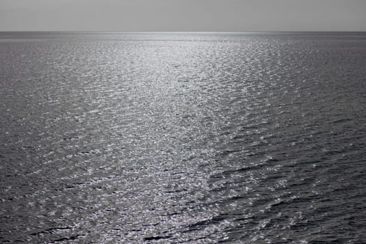 Background texture pattern of grey wind rippled Mediterranean sea.
