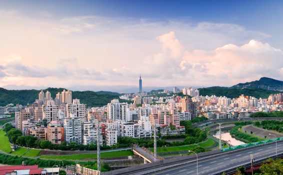 It is a cityscape photo of apartments and highway.