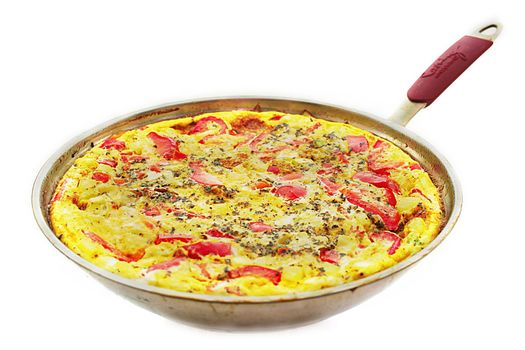 Ready omelette with vegetables in a frying pan.