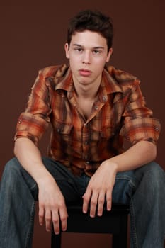 portrait of a cute caucasian guy, brown background