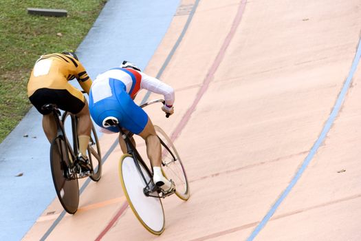 Image of participants in a cycling sprint race held at a velodrome.