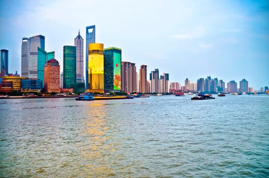 Tilted Shanghai Pudong skyline area over the river in blue sky