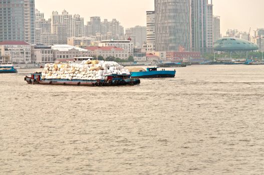 Vessel full of waste in Shanghai river