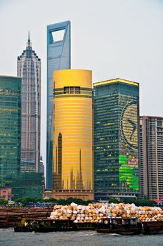 Shanghai Pudong area with vessel full of waste in the river, China