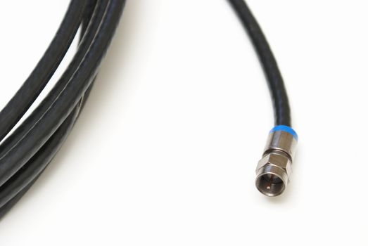 A black coaxial cable over white background.