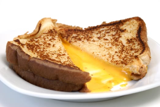 A grilled cheese sandwich cut open to show the melted cheese.
