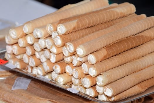 Traditional crackers filled with whipped cream at the street market
