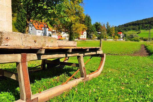 An old sleigh with the typical landscape of the Swabian Alb in the background, Baden-Wuerttemberg, Germany