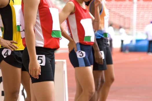 Image of female 100 meter athletes awaiting the start of their race.