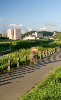 It is a beautiful cityscape of bicycle driver at riverbank.