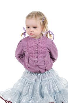 A little girl standing in studio