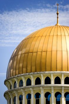 Gold coloured dome of a mosque in Malaysia.