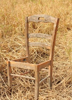 broken chair on yellow grass