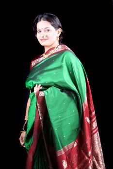 A beautiful Indian woman from the Maratha community, wearing a traditional green sari on the occasion of a festival.