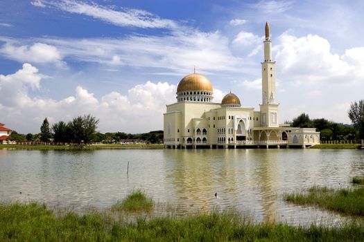 Floating mosque with gold coloured domes and minaret in Malaysia.