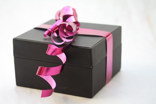 black box with purple ribbon