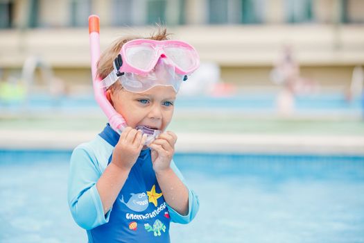 boy playing in a pool of water during the summer