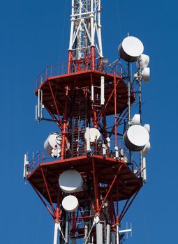 Red and white TV tower with communication antennas