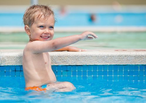 boy playing in a pool of water during the summer