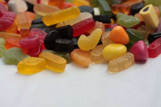 Pile of colorful candies: liquorice allsorts and wine gums