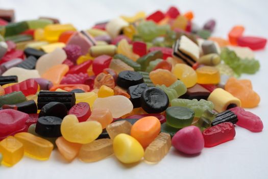 Pile of colorful candies: liquorice allsorts and wine gums