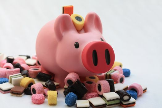 Fat pink pig on a pile of candy