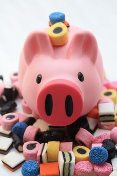 Fat pink pig on a pile of candy