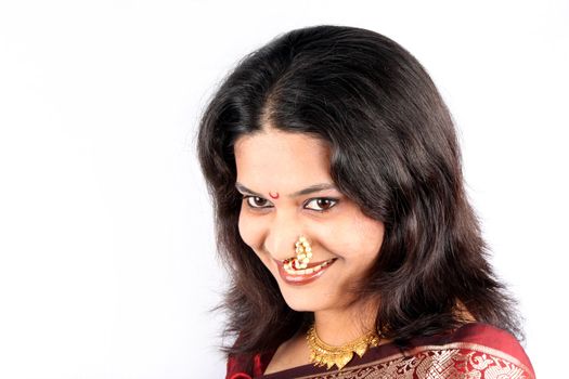 A portrait of a very pretty Indian woman with a beautiful smile, on white background.