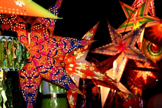 A backgorund with a view of beautifully designed colorful lanterns (also locally called as skylanters) decoration lit of the occasion of Diwali / Christmas festival in India.