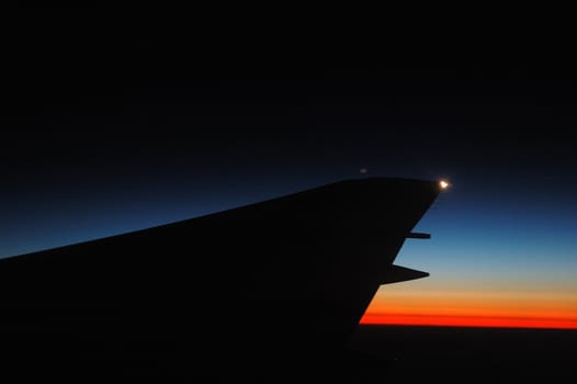 aircraft wing with blue sky as background