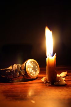 A metaphorical image of a watch and a candle, depicting a moment in time.