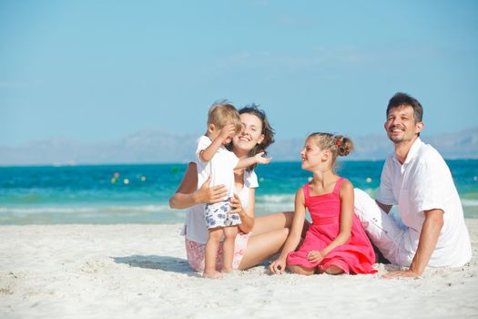 Portrait of happy young family on tropical vacation