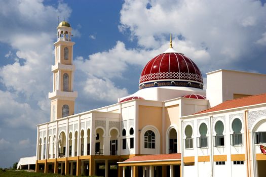 A modern red domed mosque in Malaysia.